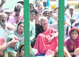 Social activist Medha Patkar along with the villagers affected by Sardar Sarovar project during a protest in New Delhi on Monday.