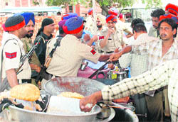 Policemen have food at an eating joint in Phase X, Mohali,