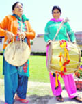 Sandali Devi (left) and Makani Devi of Tehri district play the dhol and damoun
