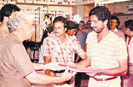 looks on; Gerishs father SP Kapoor gifting a sweater to Krish Shrikkanth