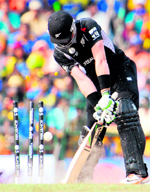 New Zealands Martin Guptill is bowled out by Sri Lankas Lasith Malinga in Colombo on Tuesday