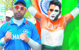 A Yuvraj look alike (left) and another fan with his body painted in the Tricolour arrive at the stadium.