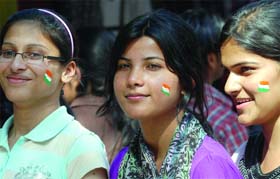 CHEERING PRETTY HARD: Indian cricket fans paint their faces for the semi-final match between India and Pakistan, in New Delhi
