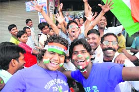 Fans gather at a shop in Sadar Bazar in Karnal to cheer the Indian cricket team during the semi-final World Cup match between India and Pakistan in Mohali