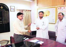 DC Vijay Singh Dahiya gives a cheque for Rs 5 lakh to Dulat sarpanch Nirmal Singh at Fatehabad