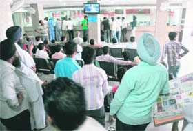 Patients and their relatives glued to at a LCD screen at the DMCH on Wednesday. 