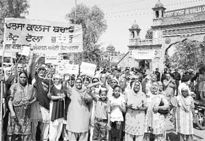 Residents of Kot Khalsa village stage a protest outside Khalsa College in Amritsar on Wednesday. 