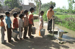 Children queue up to fetch water from a handpump in Dhaani Hari Ram village in Abohar