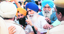 Members of Sikh religious bodies argue with police personnel during their protest in Mohali on Thursday.