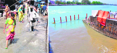People wade through sewage in the Vishnu Ghat area and (right) untreated sewage flows into the holy Ganga in Haridwar on Thursday