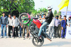 A biker performs stunts during a promotional event in Karnal.