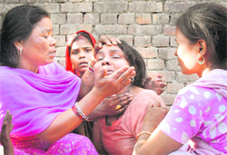 The wailing mother of seven-year-old Sonu is being consoled by her relatives in Jalandhar on Thursday