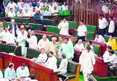 Legislators of the opposition parties stage a walkout from the Legislative Assembly in Jammu on Thursday in protest against the Bill on property tax