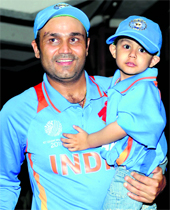 Virender Sehwag with his son after the victory against Pakistan in Mohali on Wednesday
