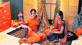 Students pose as models for Punjabi Virsa section at an INIFD exhibition