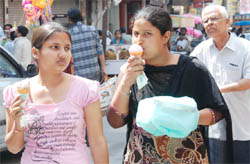 Girls enjoy ice-cream on a hot afternoon in Bathinda