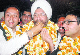 Jagmohan Singh (left) and Avtar Singh offer sweets to Kulwinder Sigh Dhaliwal, Punjab and Haryana High Court Bar Association president-elect, in Chandigarh on Friday.
