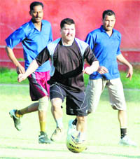 Players in action during a match in the ONGC Inter-Departmental Football Tournament in Dehradun on Friday.