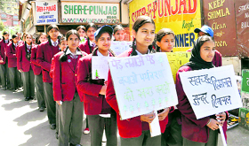 Schoolgirls hold placards during a cleanliness awareness programme in Shimla on Friday.
