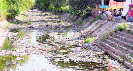 An irrigation canal full of garbage and silt in Jammu.