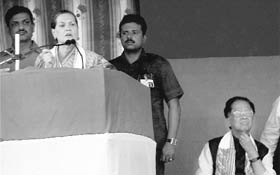 Congress chief Sonia Gandhi addresses a rally in Golaghat on Friday. Assam CM Tarun Gogoi is also seen.