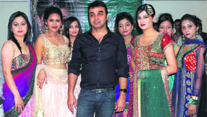 Designer Amit Kumar Kashyap with models showcasing his bridal collection