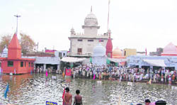 Pilgrims take a holy dip in the Saraswati Tirtha at Pehowa on the second day of the three-day Chaitra Chaudas mela 