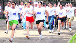 Girls take part in a mini marathon at Sector 7 in Chandigarh on Sunday