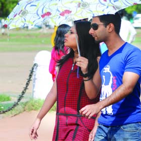 A couple takes refuge under an umbrella in New Delhi on Sunday