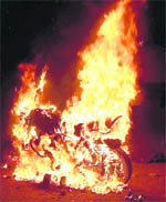 A motorcycle set aflame by irate cricket enthusiasts following a lathi charge in Dehradun on Saturday night. 
