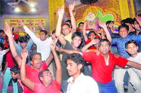 Cricket fans break into a dance at Pehowa Chowk in Kaithal on Saturday night