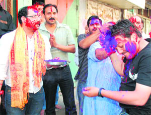 Youth play with colours in Jammu.