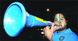 A cricket fan blows the vuvuzela after Indias win.