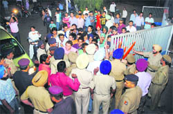 Students of the department of evening studies and members of the ABVP block gate number 2 of Panjab University during their protest on Monday. 