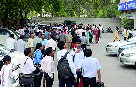 People come out from their office after feeling the earthquake at Connaught Place in New Delhi on Monday.