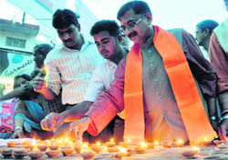 Tarun Vijay, Rajya Sabha MP, lights earthen lamps on the occasion of the Hindu New Year in Dehradun on Monday.