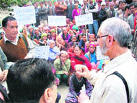 Villagers protest against an assessment panel in Faryari village on Monday. 