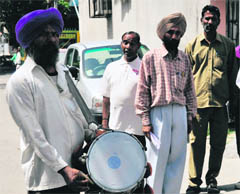 Employees of the Ludhiana Improvement Trust make a public announcement, asking residents to follow building bylaws or face cancellation of allotment, at Sant Ishar Singh Nagar in Ludhiana