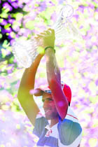 Novak Djokovic celebrates with the trophy after winning the mens singles at the Sony Ericsson Open on Sunday. 