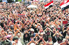 Anti-regime protesters raise their hands during a demonstration calling for the ouster of Yemeni President Ali Abdullah Saleh in central Sanaa on Monday