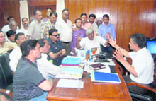 State DGP JS Pandey talks to Congress workers in Dehradun on Tuesday. 