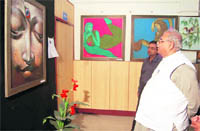Uttarakhand Assembly Apeaker Harbans Kapoor looks at a painting at the UGB Art Gallery in Dehradun on Tuesday. 