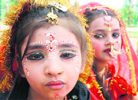 Child beggars dressed up as goddess during the Navratra festival at a temple in Jammu 