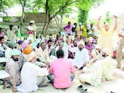 Villagers raise anti-government slogans at Shahkot on Tuesday.
