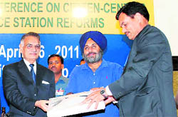Governor Shivraj Patil (left) honours Ishwar Singh, Commissioner of Police, Ludhiana, at the Global Conference on Citizen-centric police station reforms in Amritsar on Tuesday. Also in the picture is Deputy Chief Minister Sukhbir Singh Badal.