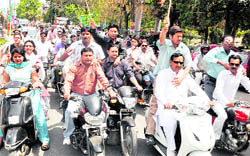 BJP workers take out a rally on the 31st founders day of the party in Dehradun on Wednesday