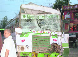 The mangled remains of the bus that hit a police picket in Dehra