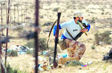 A rebel fighter takes up a position in the desert near the oil rich town of Brega on Wednesday.