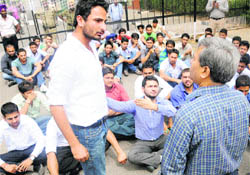 A PUSU activist argues with a teacher during a protest outside the PU VCs office in Chandigarh on Thursday.
