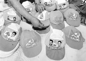 Caps bearing symbols of various political parties on display at a shop in Kolkata
